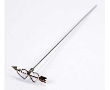 A white metal hat pin with finial modelled as two hearts struck by an arrow, unmarked, length 21.5cm.