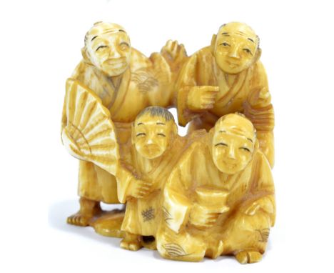 A Japanese carved ivory netsuke of figures in traditional dresses, signed, height 4cm.