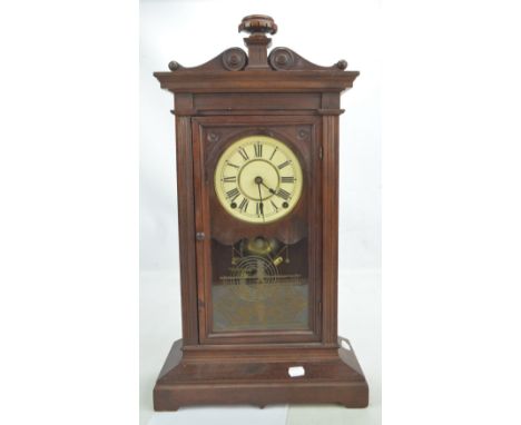 A circa 1900 oak bracket clock, the white dial set with Roman numerals, height 62cm.