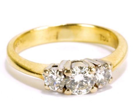 An 18ct yellow gold and diamond three stone ring, the central stone approx 0.2cts, size H 1/2, approx 3.7g.