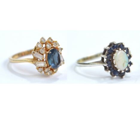 An unmarked yellow metal blue and white stone cluster ring, size Q, and an unmarked white metal opal and blue stone dress rin