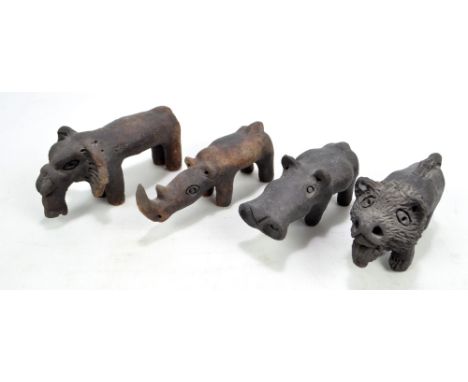 Four ceramic figures of animals including a rhinoceros and an elephant, length 16cm (4).