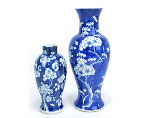 A late 19th/early 20th century Chinese porcelain baluster vase painted in underglaze blue with blossoming prunus, bearing Kan