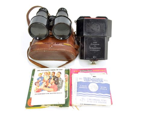 A vintage Viewmaster stereoviewer with light box attachment, sundry reels, and a pair of leather cased binoculars.