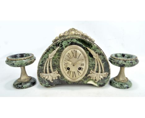 An Art Deco green marble mantel clock garniture, the domed clock with applied silvered ornaments and details, the oval dial s