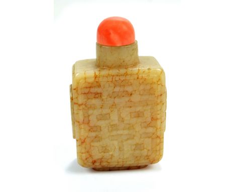 An early to mid-19th century Chinese cream jade snuff bottle of rectangular form, with overall crackle effect brown inclusion