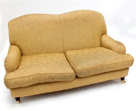 A reproduction cream upholstered two seater sofa. 