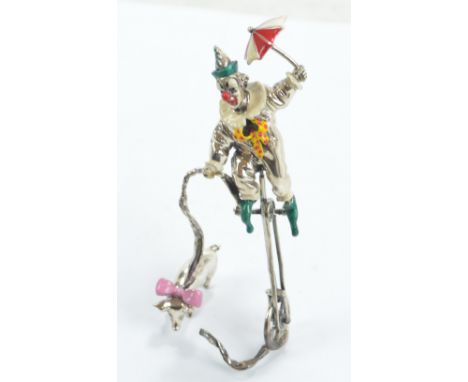 An Italian 925 silver and enamel clown on unicycle with pig, with import marks, height 14cm (af). CONDITION REPORT: The botto