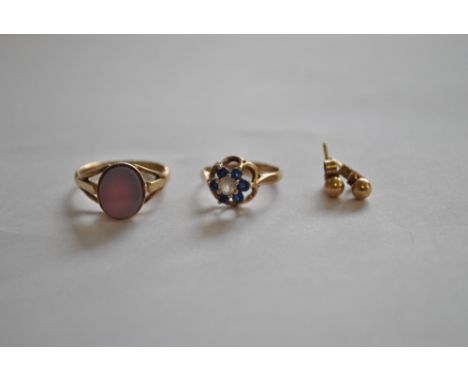 A 9ct yellow gold signet ring, size K, a 9ct yellow gold paste set dress ring, size F 1/2, and a pair of unmarked yellow meta