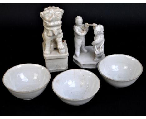 A Chinese blanc de chine figure of a Dog of Fo on rectangular base, height 12cm, a figure group of men playing instruments on