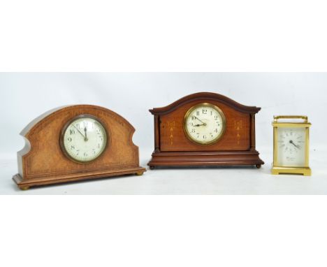 An Edwardian mahogany and inlaid domed timepiece inscribed 'Walker & Hall Ltd' to the circular dial set with Arabic numerals,