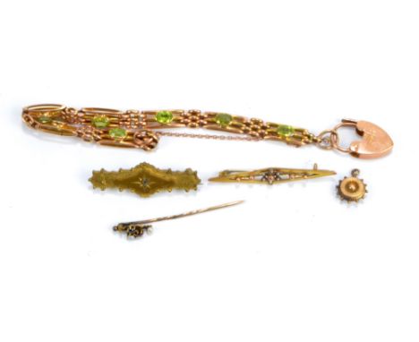 A group of jewellery comprising 9ct gold bracelet set with oval cut green stones, approx 13.4g, a yellow metal brooch set wit