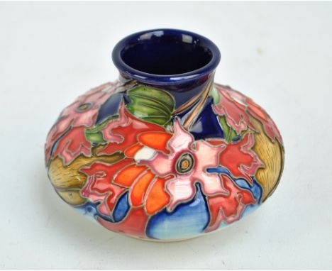 MOORCROFT; a floral tubeline decorated squat vase on blue ground, limited edition 41/75, Australia 2012 and other impressed m