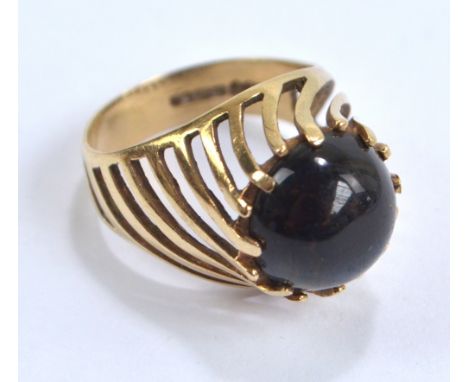 A 9ct yellow gold and dark cabochon stone spiral motif dress ring, size O, approx 5.5g.