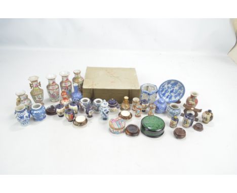 A group of various Japanese Meiji period and later Satsuma miniature vases, a pair of cups and saucers, blue transfer decorat