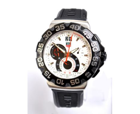TAG HEUER; a gentleman's Formula 1 Grand Date wristwatch with black bezel, boxed with papers. CONDITION REPORT: Barely signs 