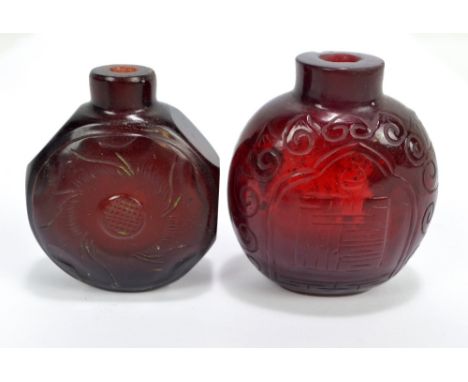 A Chinese red glass snuff bottle of flat globular form, incised decorated with a stylised seal mark within a border of whirls