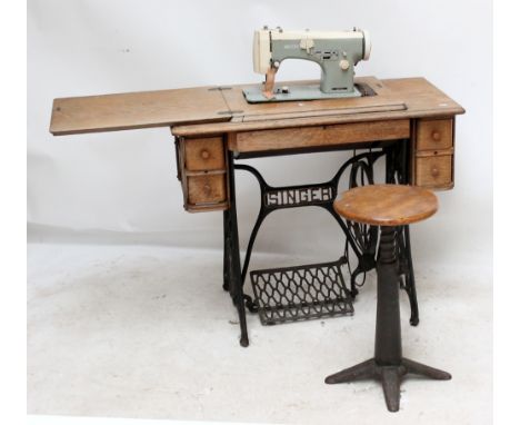 A Singer treadle base now fitted with a Necchi electric sewing machine, and stool (2).