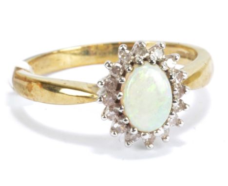 A 9ct white gold diamond and opal oval cluster ring, size O, approx 3g.