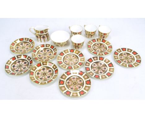 A Royal Crown Derby Imari part tea set comprising cream jug, sugar bowl and four cups, saucers and side plates, all numbered 