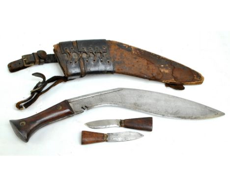 A mid-20th century MK IV kukri with karda and chakmak in leather bound scabbard, unmarked, blade length approx 29.5cm.  CONDI