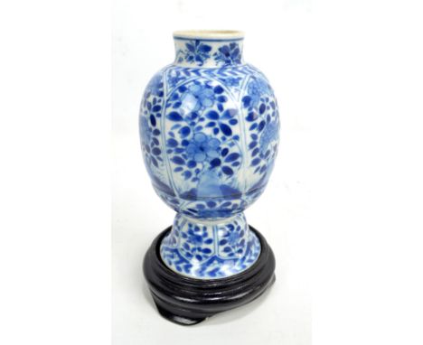 A Chinese Kangxi porcelain vase of globular form with raised neck on bell shaped base, overall painted in underglaze blue wit