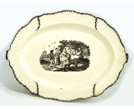 A late 18th century creamware leaf moulded platter, probably Leeds, with transferred rural figural scene, unmarked, length 42