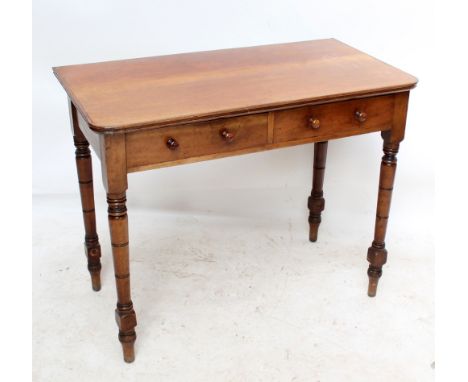 A late Victorian two drawer side table on ring turned and block legs, width 97cm.