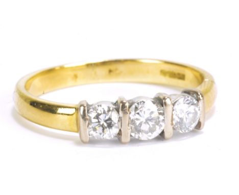 An 18ct yellow gold and diamond three stone ring, size K, approx 3.0g.