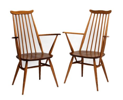 ERCOL; two stick back elbow chairs with swept arms and turned legs. CONDITION REPORT: Heavy wear to arms and legs, surface sc
