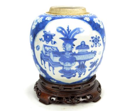 A 19th century Chinese ginger jar painted in underglaze blue with two opposing shaped panels depicting Buddhist auspicious sy