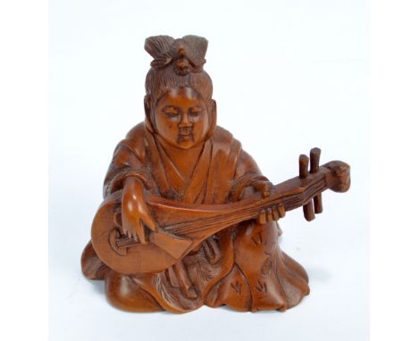 A 19th century Chinese wooden carving of a seated man playing pipa, with etched three character mark to base, height 6.5cm.