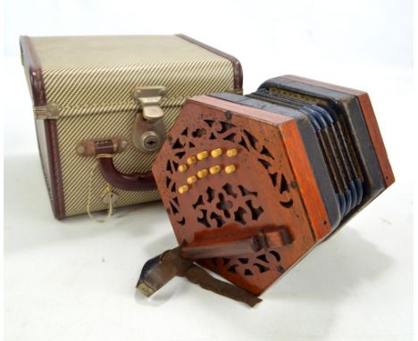 A Lachenal & Co 21 key mahogany accordion, with later case and tutorial booklet. CONDITION REPORT: All buttons work and make 