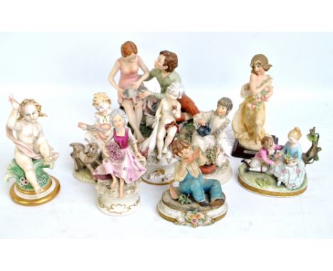 Seven Capodimonte figures including a boy and girl playing with cats, a boy eating a watermelon and a putto, also two further