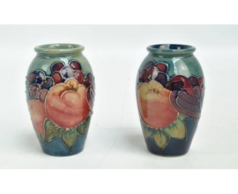 MOORCROFT; a pair of tubeline decorated 'Finches' pattern inverted baluster vases, each with impressed marks to base, dated 1