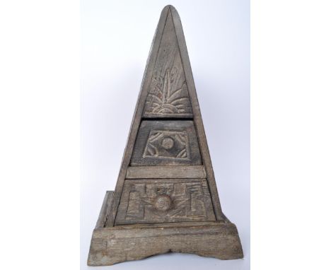 A 20th century tribal carved wood pyramid shaped spice chest. The box having carved human figures to the sides and front with