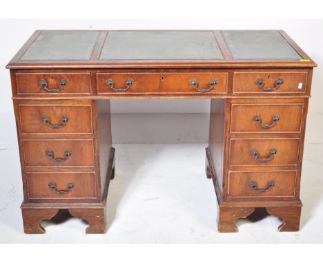 A reproduction mahogany and leather twin pedestal office desk being raised on bracket feet with pedestals having banks of dra