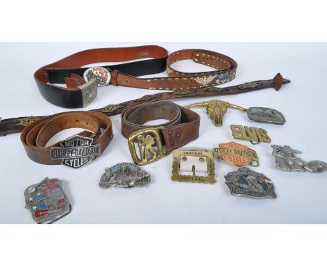 An assortment of vintage 20th century belts and belt buckle to include a series of embossed and tooled leather belts with vin