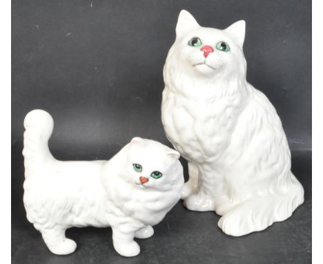 Two vintage 20th century Beswick ceramic cat figures to include the figurine of a sitting white cat, together with a smaller 