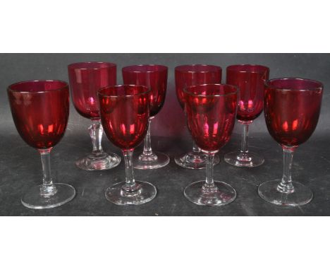 An assortment of eight vintage 20th century cranberry baluster shaped dessert glasses with thin stems on round bases. Each me