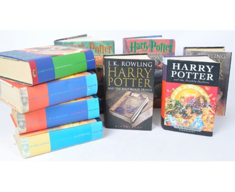 A collection of nine J. K Rowling 'Harry Potter' hardback cover books with illustrated dust covers to include four 'Harry Pot