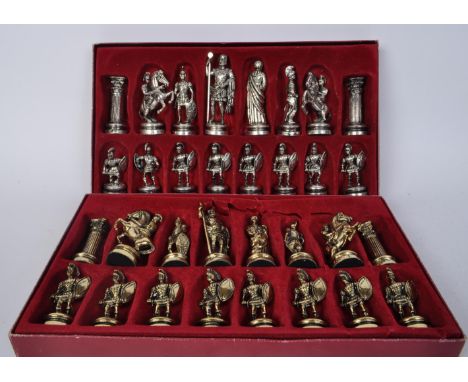 Two boxed sets of vintage 20th century Marinakis spelter chess piece figures in the form of roman gladiators, pillars and emp