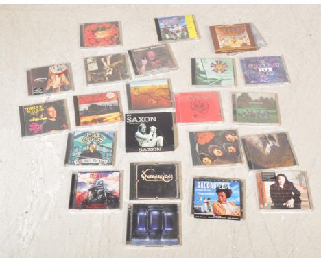 A collection of vintage compact disc and cassette tapes. To include artist such as; ACDC, Richard Marx, Coldplay, Oasis, Quee