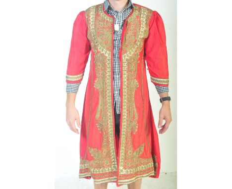 A vintage 20th century Indian Kaftan having brass embroidered floral decoration studded with polychrome glass stones.&nbsp;