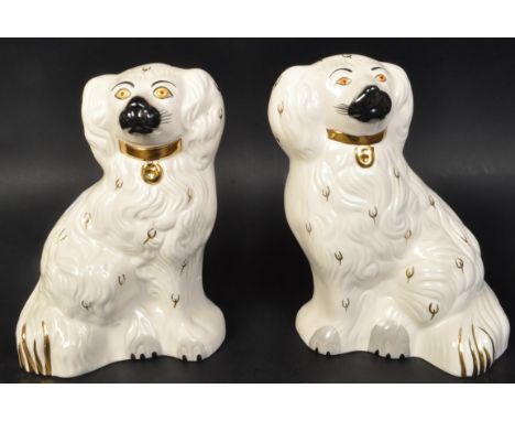 A pair of vintage 20th Century English Royal Doulton Staffordshire style dogs. In a seated position with gilt decoration on a