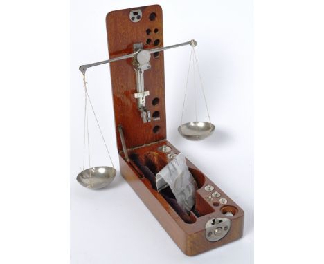 A pair of Victorian 19th century mahogany cased apothecary portable scale having twin bowl dishes with allocated weights. Wit