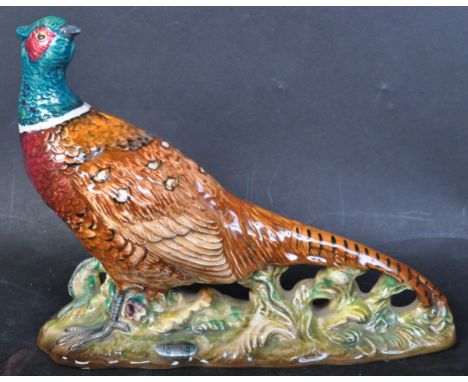 A vintage mid 20th century Beswick ceramic game bird figure of a pheasant. Painted in bright colours. Impressed to its unders