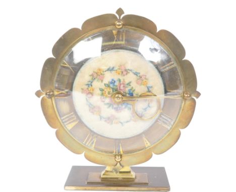 A vintage 20th century circa. 1940's Smiths eight day brass mantel clock having needlepoint embroidery to the centre on silk 