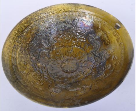 A Chinese Song dynasty style green glazed ceramic bowl with central character marks and impressed dragons to the interior. Me
