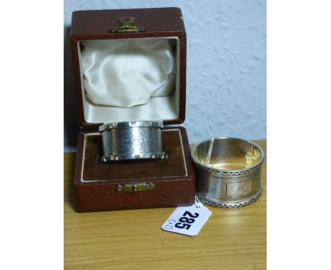 A HM SHEFFIELD SILVER NAPKIN RING WITH ENGINE TURNED DECORATION AND ENGRAVED CARTOUCHE AND A CASED HM BIRMINGHAM SILVER NAPKI